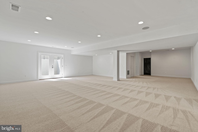 basement with light carpet and french doors