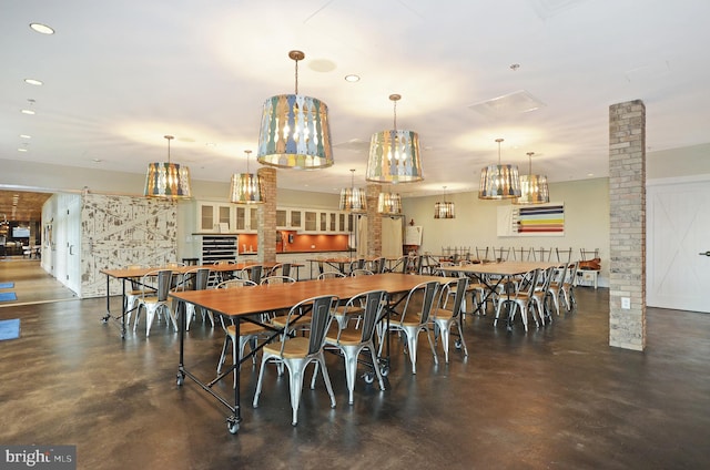 dining area featuring brick wall and ornate columns