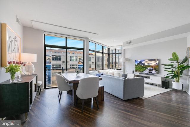 dining area featuring dark hardwood / wood-style floors and a wall of windows