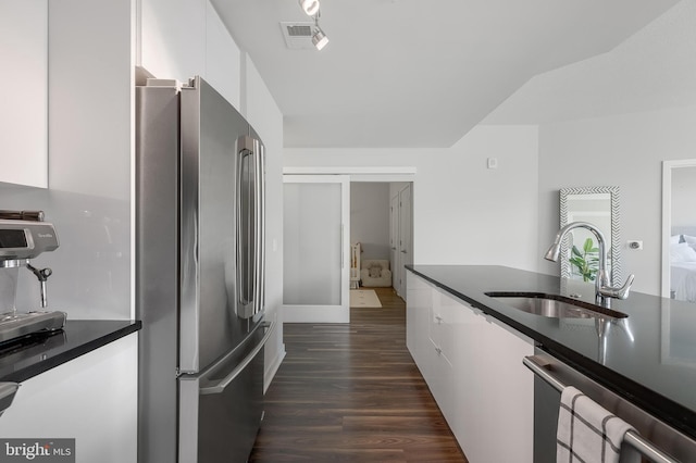 kitchen with white cabinetry, sink, stainless steel appliances, and dark hardwood / wood-style floors