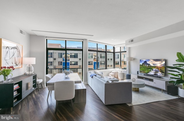 living room with expansive windows, dark hardwood / wood-style flooring, and a textured ceiling