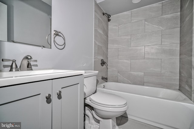 full bathroom featuring tiled shower / bath, vanity, and toilet