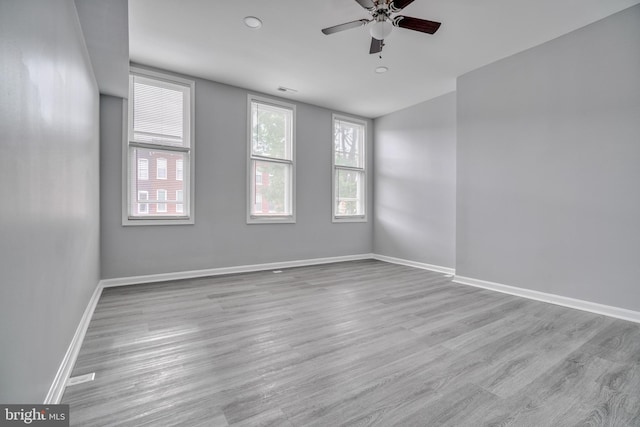 spare room with light hardwood / wood-style flooring and ceiling fan