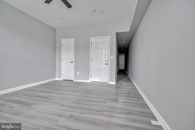 unfurnished bedroom with ceiling fan and light hardwood / wood-style flooring