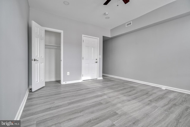 unfurnished bedroom with ceiling fan and light hardwood / wood-style flooring