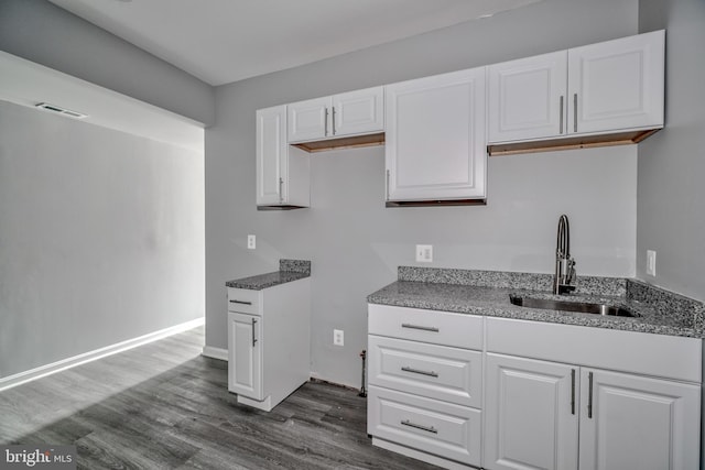 kitchen featuring white cabinetry, sink, and dark wood-type flooring