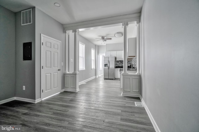 corridor with ornate columns and hardwood / wood-style floors