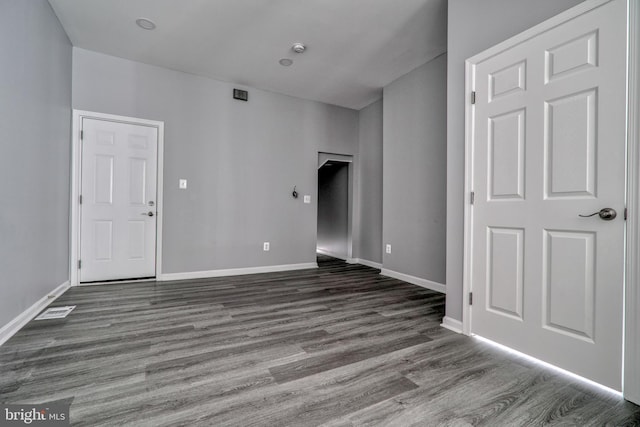 unfurnished living room featuring dark hardwood / wood-style flooring