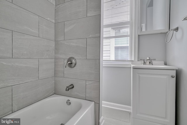 bathroom featuring vanity and tiled shower / bath