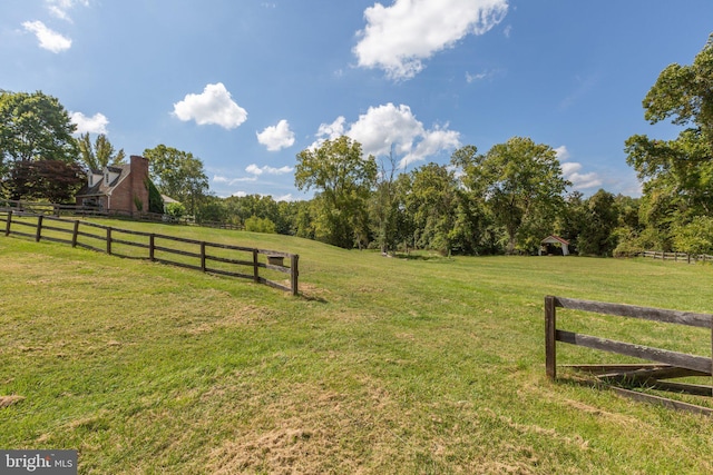 view of yard with a rural view