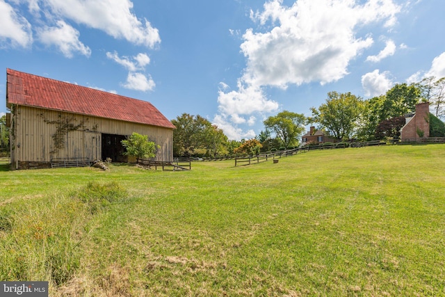 view of yard with a rural view and an outdoor structure