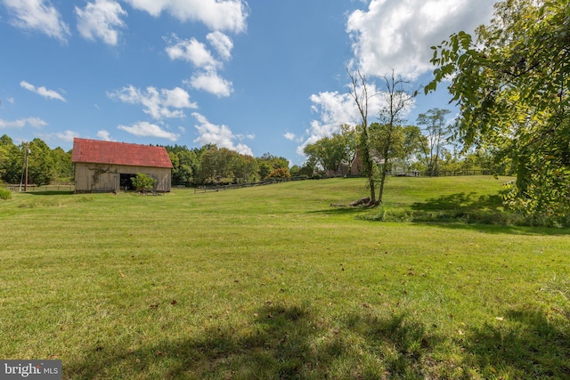 view of yard with a rural view and an outbuilding