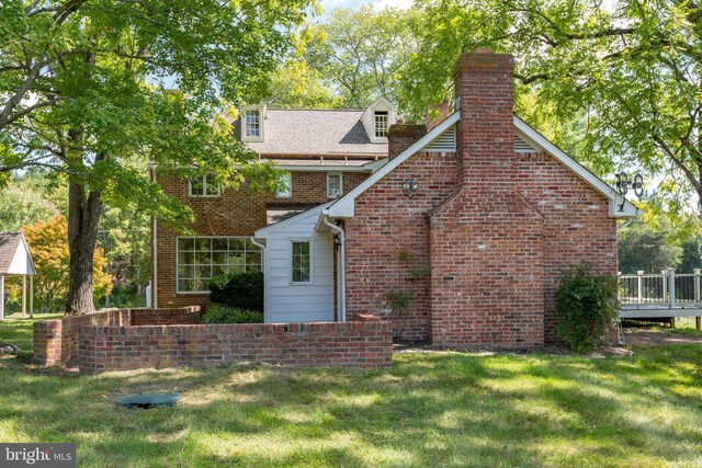 rear view of property featuring a yard