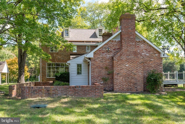 1791 Warrenton Rd, Fredericksburg, VA 22406 - rear view of house featuring a deck, a lawn, brick siding, and a chimney