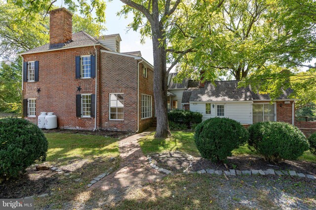 back of house featuring a yard