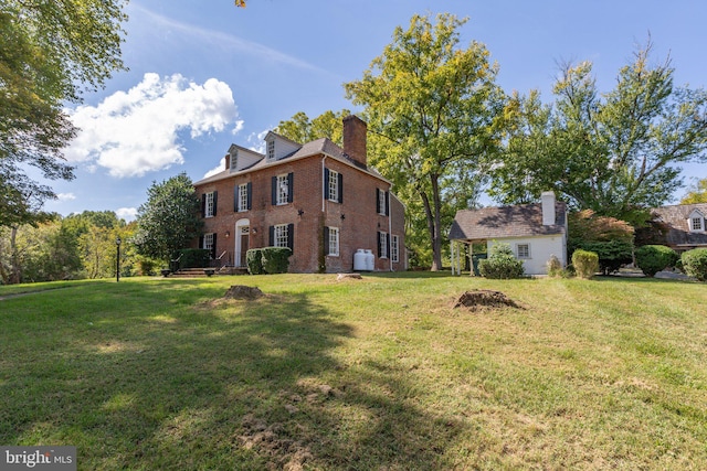 1791 Warrenton Rd, Fredericksburg, VA 22406 - view of side of property featuring a chimney, a lawn, and brick siding