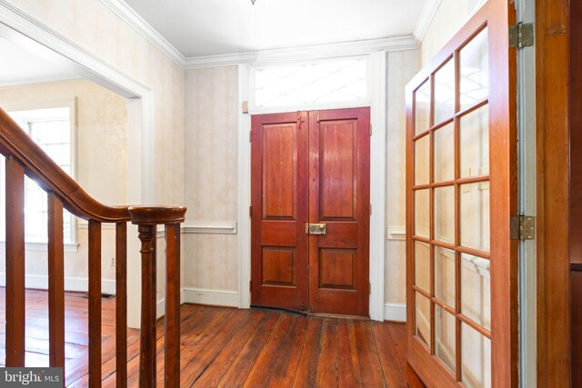 entryway with dark hardwood / wood-style floors and ornamental molding