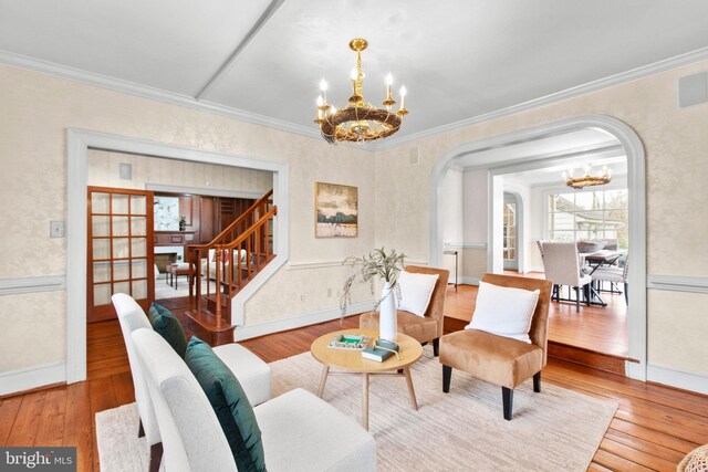 unfurnished living room featuring crown molding, an inviting chandelier, dark wood-type flooring, and a brick fireplace