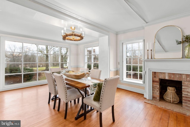 1791 Warrenton Rd, Fredericksburg, VA 22406 - dining space featuring ornamental molding, a chandelier, hardwood / wood-style floors, and a brick fireplace