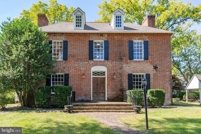 1791 Warrenton Rd, Fredericksburg, VA 22406 - colonial house featuring a chimney, a front yard, and brick siding