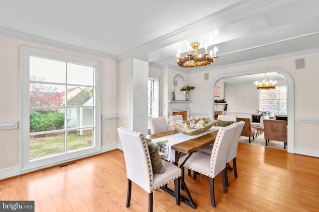 1791 Warrenton Rd, Fredericksburg, VA 22406 - dining room featuring a chandelier, arched walkways, wood finished floors, ornamental molding, and plenty of natural light