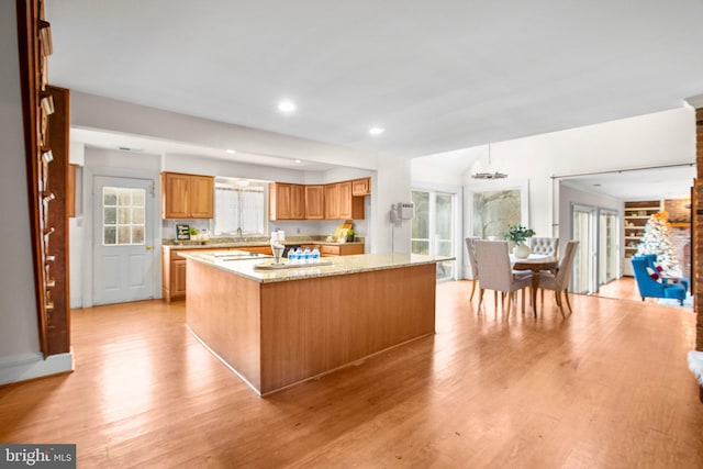 1791 Warrenton Rd, Fredericksburg, VA 22406 - kitchen featuring light wood finished floors, a kitchen island with sink, recessed lighting, light stone counters, and a chandelier