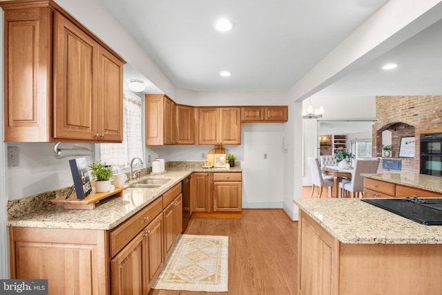 1791 Warrenton Rd, Fredericksburg, VA 22406 - kitchen with black appliances, light stone countertops, light wood finished floors, brown cabinets, and recessed lighting