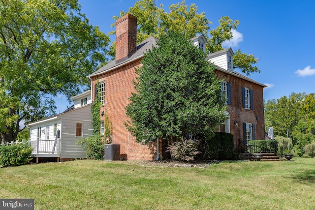 view of property exterior with a yard and central AC unit