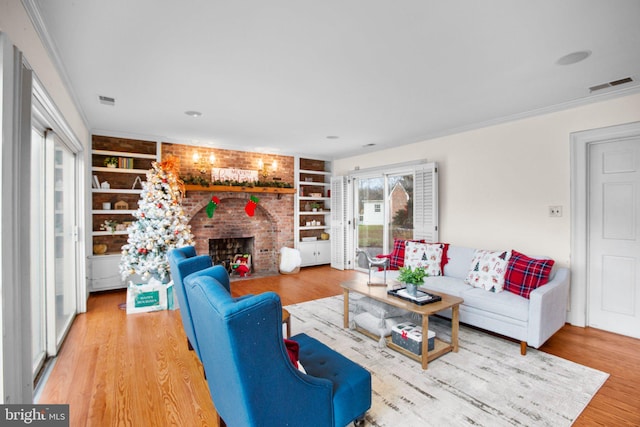 1791 Warrenton Rd, Fredericksburg, VA 22406 - living room with built in shelves, a brick fireplace, wood finished floors, and crown molding