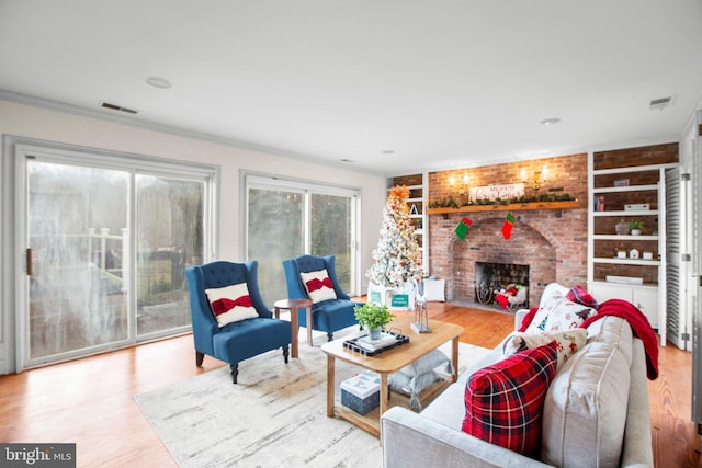 1791 Warrenton Rd, Fredericksburg, VA 22406 - living area with built in shelves, wood finished floors, a fireplace, and crown molding