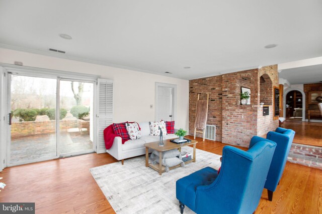 unfurnished living room featuring light hardwood / wood-style floors and ornamental molding