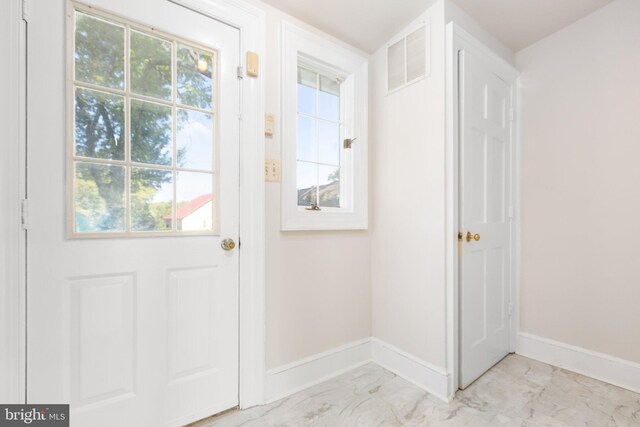 unfurnished living room featuring built in shelves, hardwood / wood-style flooring, ornamental molding, and a brick fireplace