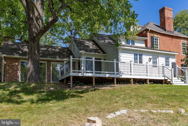 1791 Warrenton Rd, Fredericksburg, VA 22406 - rear view of house featuring brick siding, a deck, a yard, and a chimney
