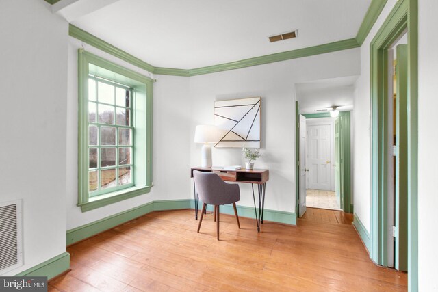 spare room with hardwood / wood-style flooring and ornamental molding