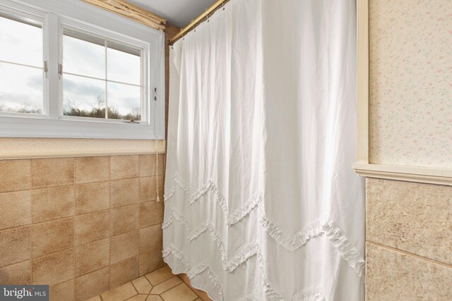 bathroom with tile walls and sink