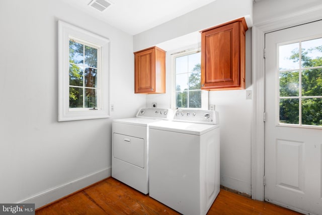 1791 Warrenton Rd, Fredericksburg, VA 22406 - laundry room with cabinet space, washer and dryer, healthy amount of natural light, and wood finished floors