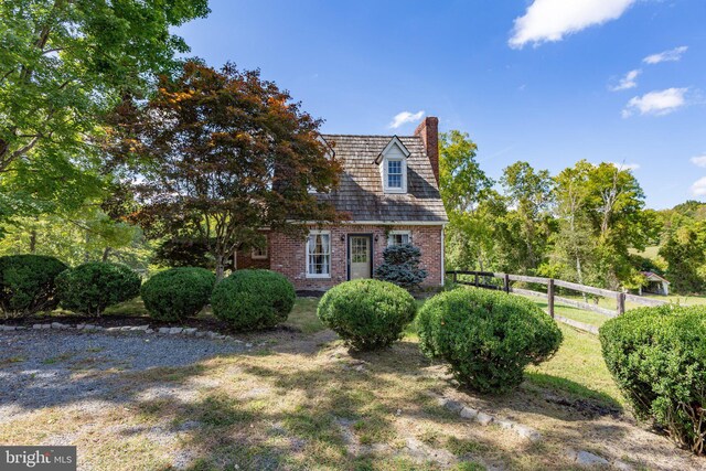 rear view of house featuring a lawn and a wooden deck