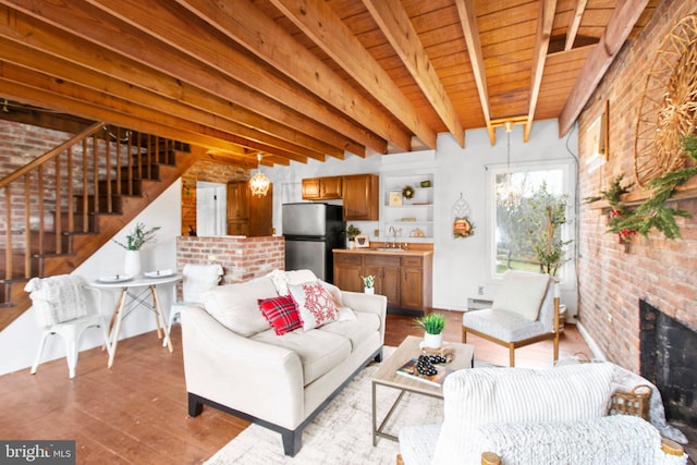 1791 Warrenton Rd, Fredericksburg, VA 22406 - living room with stairs, wood finished floors, brick wall, a wood ceiling with exposed beams, and a brick fireplace