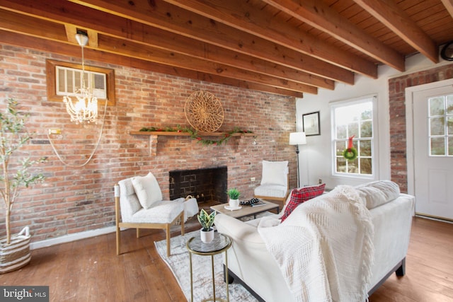 1791 Warrenton Rd, Fredericksburg, VA 22406 - living room with a wooden ceiling with exposed beams, hardwood / wood-style floors, a brick fireplace, a chandelier, and brick wall
