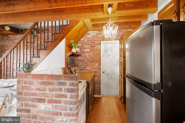 1791 Warrenton Rd, Fredericksburg, VA 22406 - kitchen featuring freestanding refrigerator, brick wall, light wood finished floors, beam ceiling, and open shelves