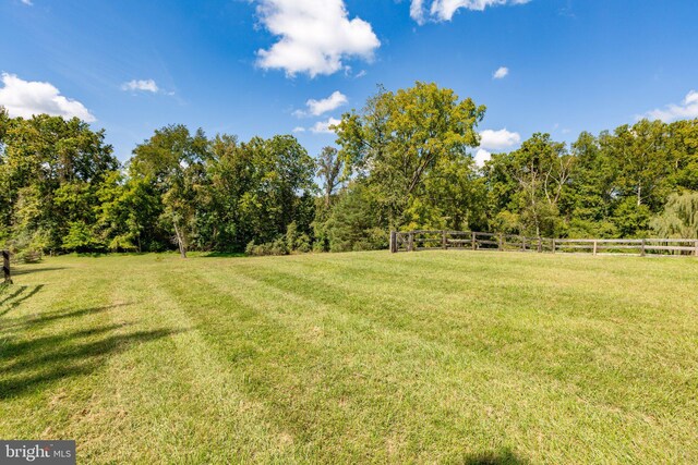 view of yard with a rural view and an outbuilding