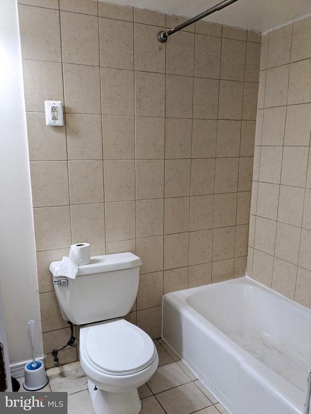 bathroom featuring toilet, tile patterned flooring, and tub / shower combination