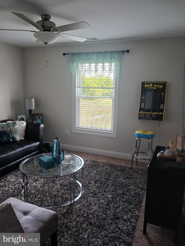 living room with ceiling fan and carpet floors