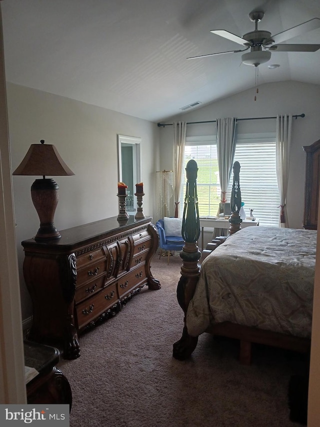 carpeted bedroom with ceiling fan and vaulted ceiling