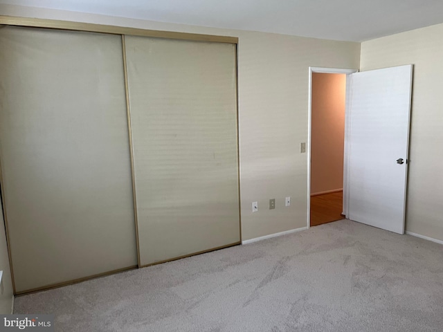 unfurnished bedroom featuring light carpet