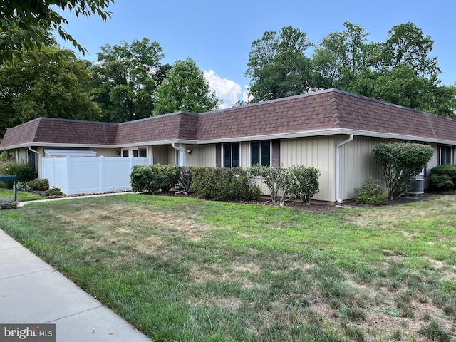 single story home featuring a front yard and central air condition unit