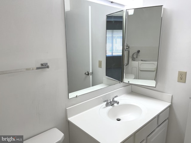 bathroom featuring vanity and toilet