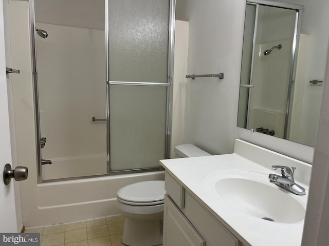 full bathroom with tile patterned flooring, bath / shower combo with glass door, vanity, and toilet