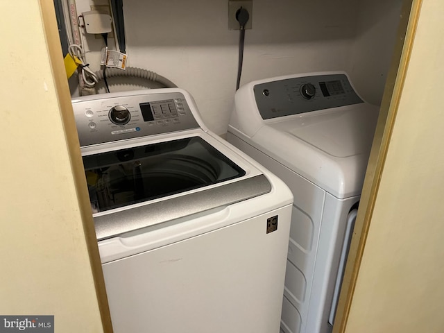 washroom featuring washer and clothes dryer