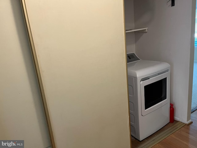 laundry area featuring light wood-type flooring and washer / clothes dryer